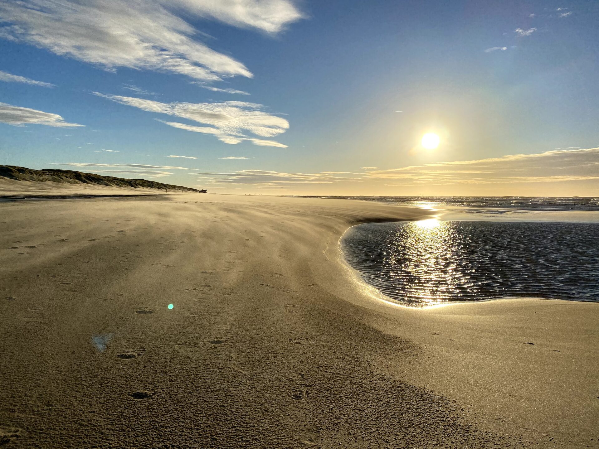 Strand met zon op het water